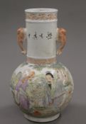 A small Chinese coloured porcelain vase decorated with figures. 23.5 cm high.
