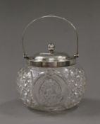 A silver mounted cut glass biscuit barrel. 13 cm high.