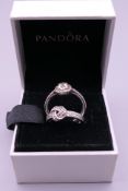 Two silver Pandora rings in a Pandora ring box. Ring size N and J/K.