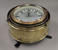 A large 36 cm diameter Kelvin and Hughes brass dry compass/binnacle.