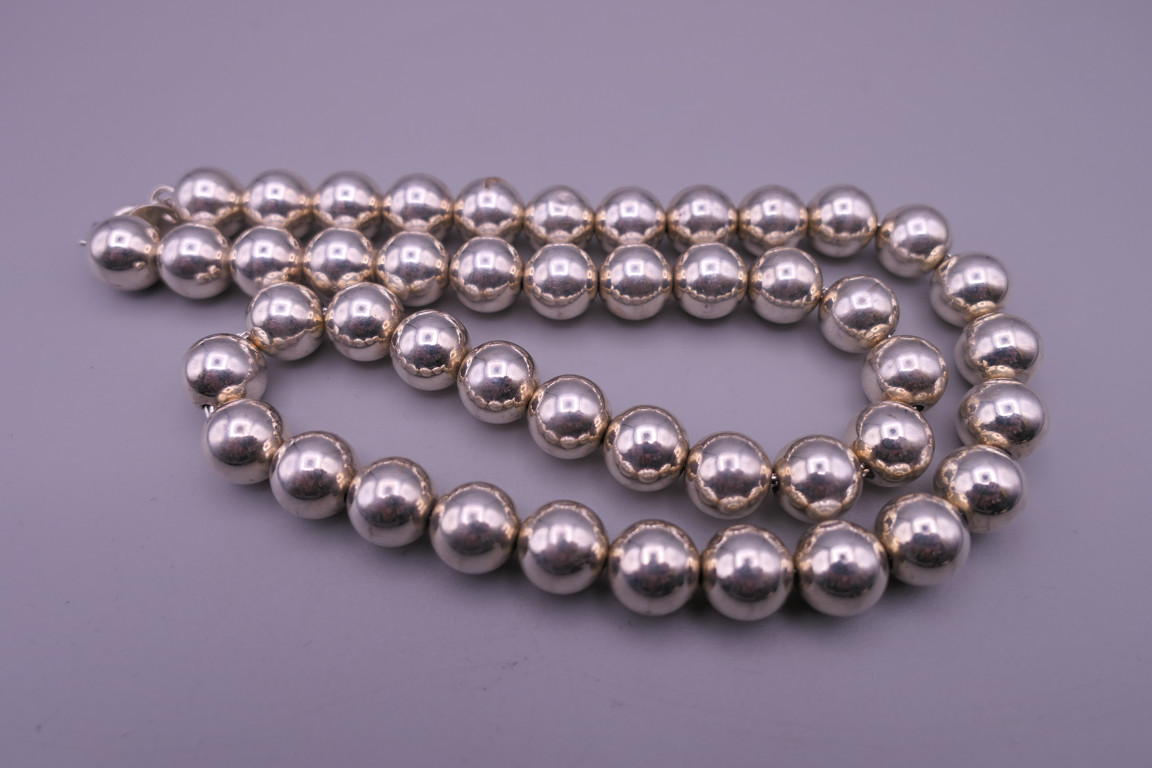 A ladies Tiffany silver bubble necklace, with UK Tiffany hallmarks on chain. 44 cm long. 47. - Image 2 of 5