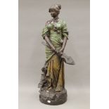 An Ernst Wahliss pottery model of a young lady holding a musical instrument. 85 cm high.