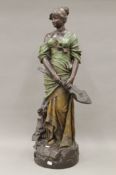 An Ernst Wahliss pottery model of a young lady holding a musical instrument. 85 cm high.