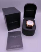 A boxed Armani wristwatch.