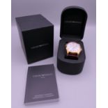 A boxed Armani wristwatch.