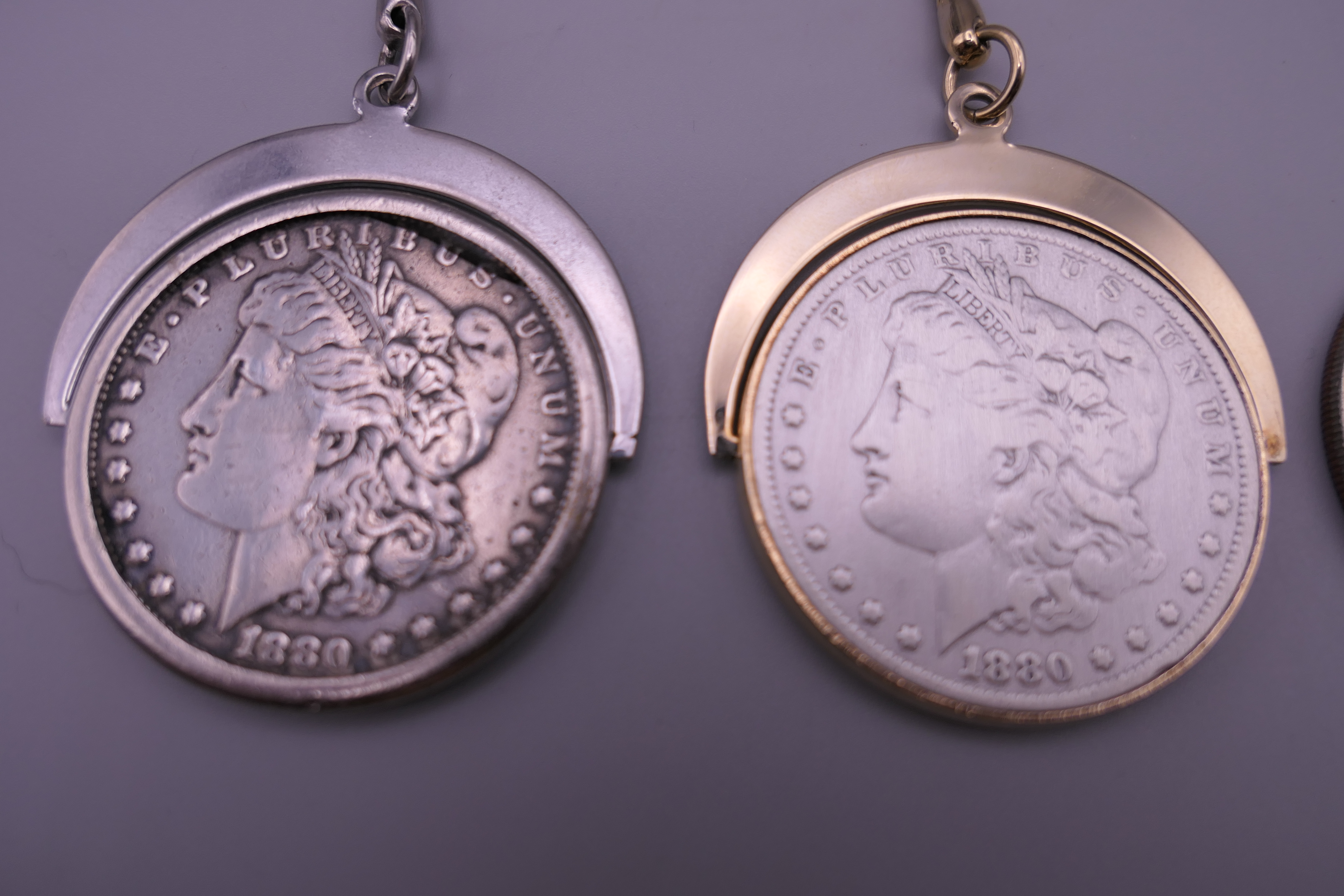 Two 1880 silver dollars each set as a keyring and a 1974 one dollar coin. - Image 2 of 5