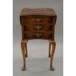 A burr walnut kidney shape three drawer twin flap side table. 67.5 cm high.