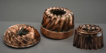 Three antique copper jelly moulds. The largest 12 cm high.