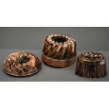 Three antique copper jelly moulds. The largest 12 cm high.