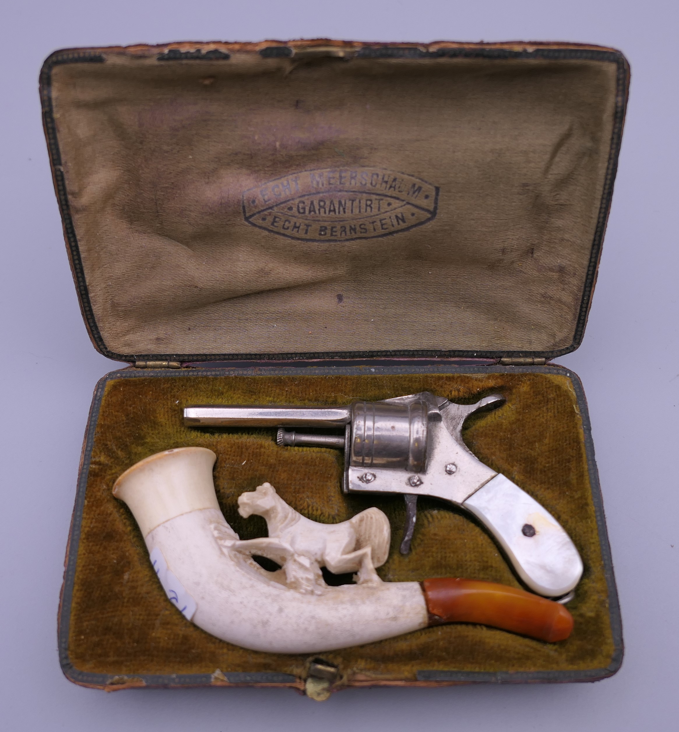 A late 19th century cased cigar cutter and Meerschaum pipe, the cutter formed as a revolver.