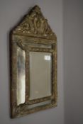 A 19th century pressed brass framed mirror. 32.5 cm wide.