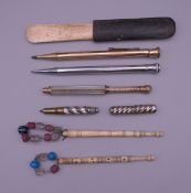 Four pens, two bone lace bobbins and a blood letter.