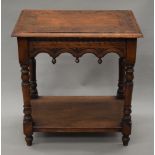 A Victorian carved oak side table. 66 cm long.