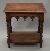 A Victorian carved oak side table. 66 cm long.