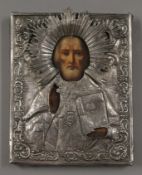 A Russian silver clad religious icon. 18 cm high.