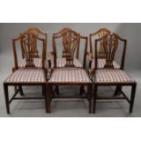 Seven various shield back dining chairs.