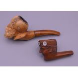 A 19th century Meerschaum pipe and a carved wooden pipe, each modelled as a male head.