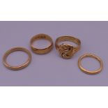 Three 18 ct gold rings (16.4 grammes) and a 22 ct gold ring (3.4 grammes).