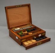 A brass mounted mahogany games box. 24.5 cm wide.
