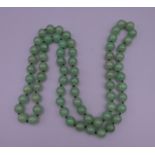 A string of jade beads. 88 cm long.