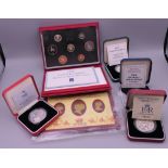 A collection of four silver proof coins and 1991 proof coins, etc.