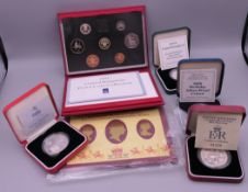 A collection of four silver proof coins and 1991 proof coins, etc.