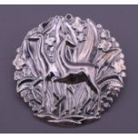 A Danish sterling silver brooch decorated with deer. 4 cm diameter.