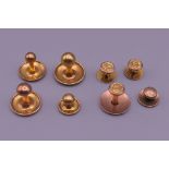 A quantity of 9 ct gold studs (5.3 grammes) and two 18 ct gold studs (2.6 grammes).