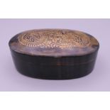 A vintage Chinese tortoiseshell oval box with carved gilded dragon to lid. 9.5 cm long.