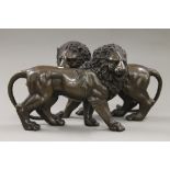 A pair of bronze lions. 32 cm long.