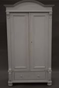 A white painted Continental pine knock down wardrobe. 108.5 cm wide, 187 cm high, 54.