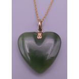 A jade pendant on a 9 ct gold chain. The pendant 2.5 cm high.