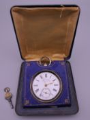A 935 silver pocket watch mounted in a watch holder/case. The case 8.5 cm wide.