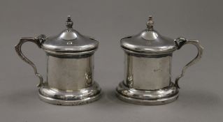 A pair of silver mustard pots. 7.5 cm high. 225.6 grammes.