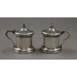 A pair of silver mustard pots. 7.5 cm high. 225.6 grammes.