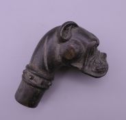 A bronze walking stick handle formed as a dog. 7 cm high.