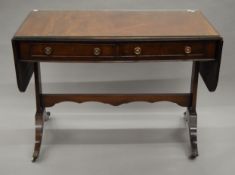 A late 19th/early 20th century mahogany sofa table. 107 cm wide flaps down.
