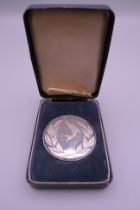 A boxed silver National Federation of Anglers medallion. 5 cm diameter. 57.8 grammes.
