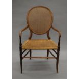 A Victorian beechwood cane and wicker open arm chair. 56 cm wide.