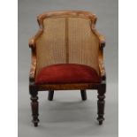 A Victorian mahogany bergere arm chair. 56 cm wide.