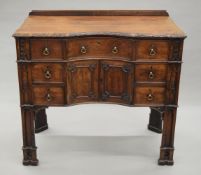 A 19th century Gothic revival mahogany dressing/writing table, with Gothic architectural designs,
