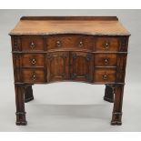 A 19th century Gothic revival mahogany dressing/writing table, with Gothic architectural designs,