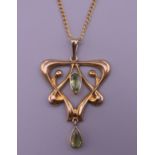 An Art Nouveau 9 ct gold peridot pendant on a 9 ct gold chain. The pendant 4 cm high. 4.