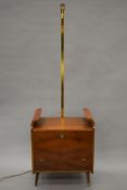 A mid-20th century cocktail cabinet with integral lamp. 178 cm high.