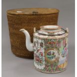 A Canton tea pot in a basket.