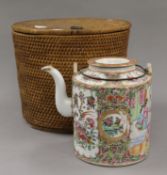 A Canton tea pot in a basket.