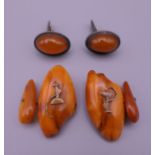 A pair of Russian silver and Baltic amber cufflinks and another pair. The former 2 cm high.