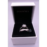 A pair of silver Pandora rings in a Pandora ring box. Ring size L/M and M/N.