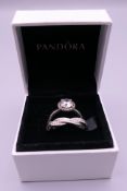 A pair of silver Pandora rings in a Pandora ring box. Ring size L/M and M/N.