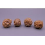 Four nut formed netsuke. Each approximately 3 cm high.